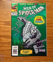 Front cover showing title, issue number 100, foil-embossed armored Spider-Man artwork