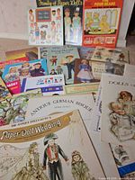 Group shot of all paper-doll books and sheets laid out