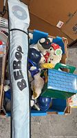 Box containing plush bears, toy helmets and Bebop kite sleeve