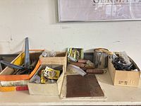Overview of five boxes with assorted hardware on shelf