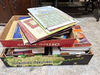 Two produce boxes filled with assorted knitting and quilting books and magazines