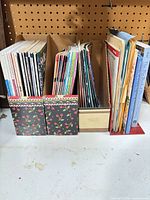 Group of magazines stored upright in holders showing volume