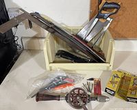 Overall lot showing crate with saws, pry bars and bagged accessories plus drill in front