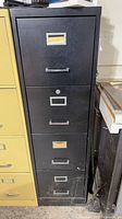 Front view of black 4-drawer cabinet showing full height and drawer handles