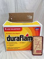 Duraflame 9-log box with Craftsman case leaning