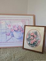 Both framed floral prints side by side