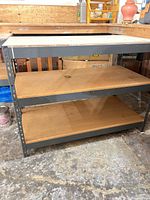 Front view showing three shelves and steel frame