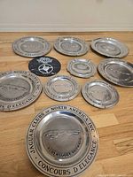Group shot showing all pewter plates and plaque