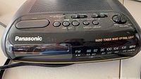 Panasonic black clock radio front view showing controls and branding