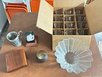 All items grouped: bowl, box of 12 tumblers, trophy base, paperweight, pewter mug, metal cup