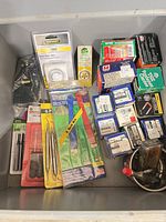 Overview of bin with tools, timers, boxed fasteners
