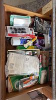 Drawer view showing multiple packaged adhesives, tapes and pads