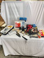 Full lot overview showing brushes, rollers, trays, drop covers, tools