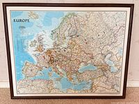 Front view of framed Europe map showing entire piece and wood frame