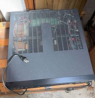 Top view of NEC AVR-1000 receiver with vented cover and power cord
