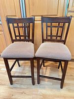 Front view of both stools showing design and upholstery