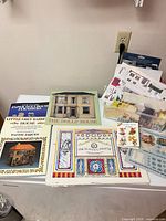 Overview of books, cut-out sheets, stickers, plastic box