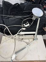 Lot overview showing desk lamp, shade sails, netting, power strip