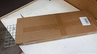 Cardboard box with folded trap grid visible