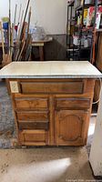 front view showing drawers, door, outlet, veneer finish