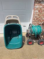 Garden dump cart next to hose reel cart