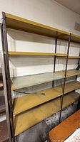 Full view of shelving unit showing two bays and multiple yellow shelves