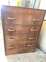 Front view of dresser showing five drawers and brass-tone pulls