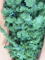 Tree foliage with pre-strung lights in carton