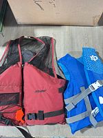 Adult and child life jackets side by side