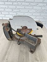 Side view of chop saw showing blade guard, fence and base