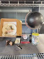 Full lot showing wall clock, globe, alarm clock, coin jar, watches, packaged pin