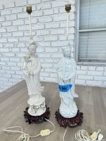 Front view of both porcelain Guanyin lamps on rosewood bases with cords