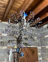 Full chandelier hanging against cinderblock wall
