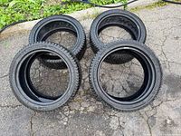 Four Michelin X-Ice tires on pavement, showing tread and sidewalls