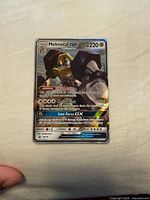 Front of Melmetal GX SM178 holo card showing artwork, stats, promo symbol