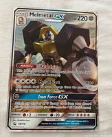 Front view of Melmetal GX jumbo promo card showing artwork, text, and condition