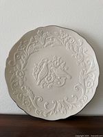 Front view of 12" Lenox plate showing full raised design and scalloped rim