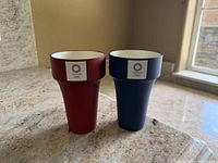 Front view showing both tumblers, colors and logos visible