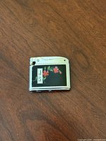 Front view of Ronson Adonis lighter showing floral enamel panel