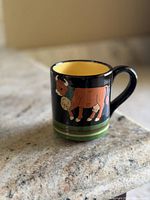 Full view of mug front showing cow artwork and color scheme