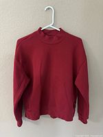 Front view of red L.L.Bean sweater on hanger
