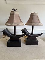 Front view of both lamps showing horn bodies, bases, shades