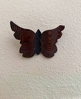 Front view of carved wooden butterfly