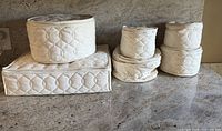 All five quilted fabric china storage cases on countertop