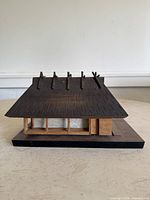 Front angled view showing roof detail, wall and base