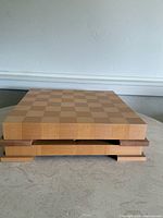 closed wood game board showing tiered base