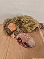Full view of doll lying on side with tag visible