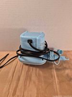 Top and side view of blue electric air pump with attached power cord