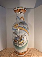 Full view of tall porcelain vase with painted scene