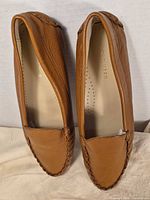 Top view of both loafers showing uppers, color and insole branding